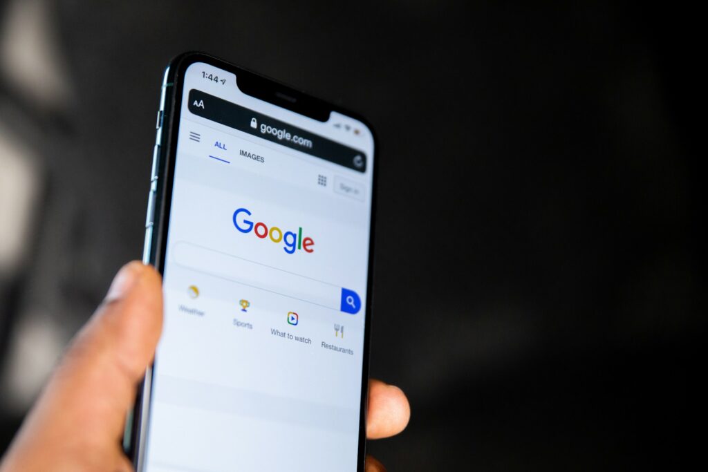 A close up shot of a phone showing the Google website home page