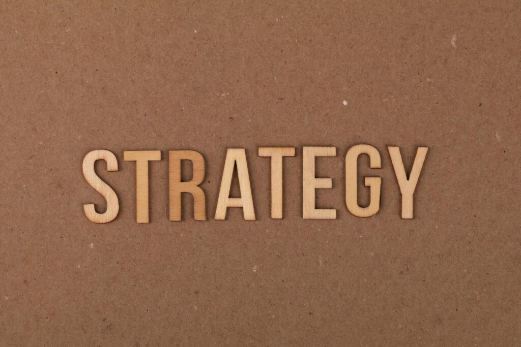 A corkboard with the word strategy in it