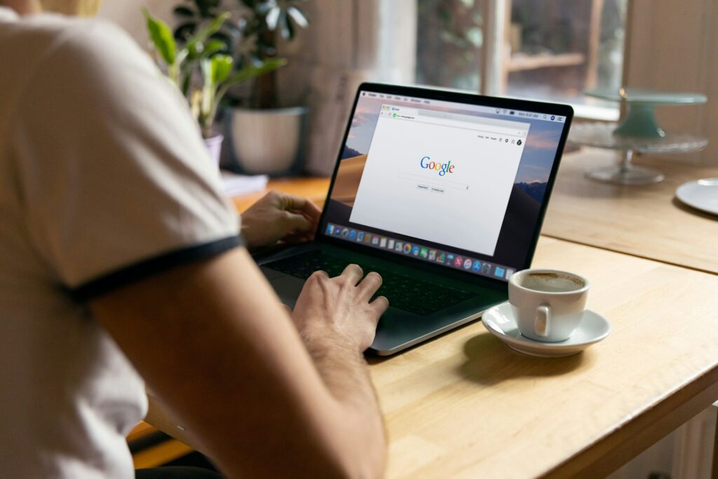 A man using his laptop to search on Google