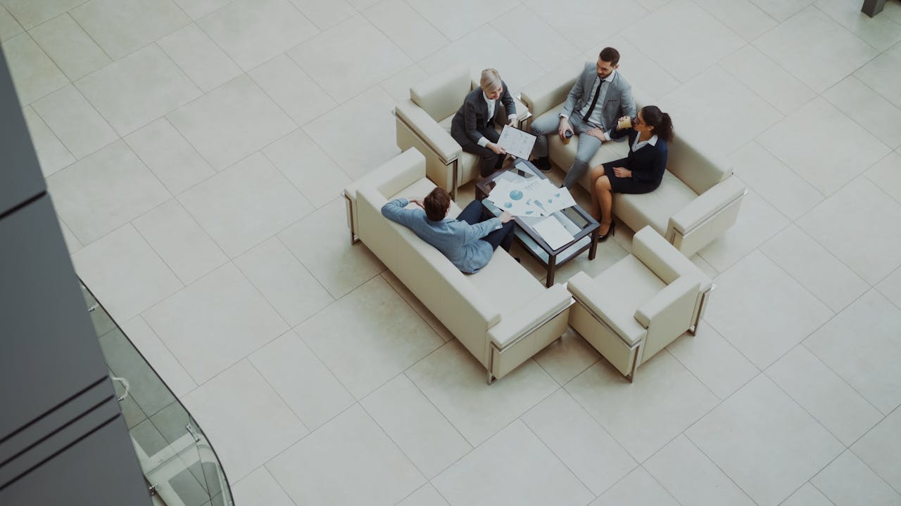 A group of business people talking about GEO Services