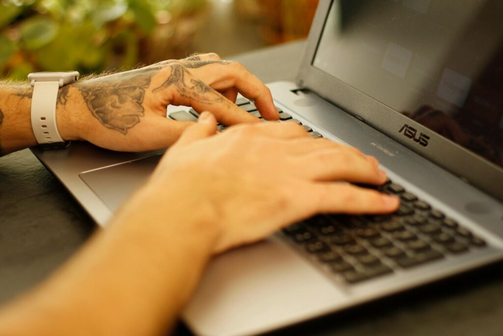 Close up of a hand using a computer