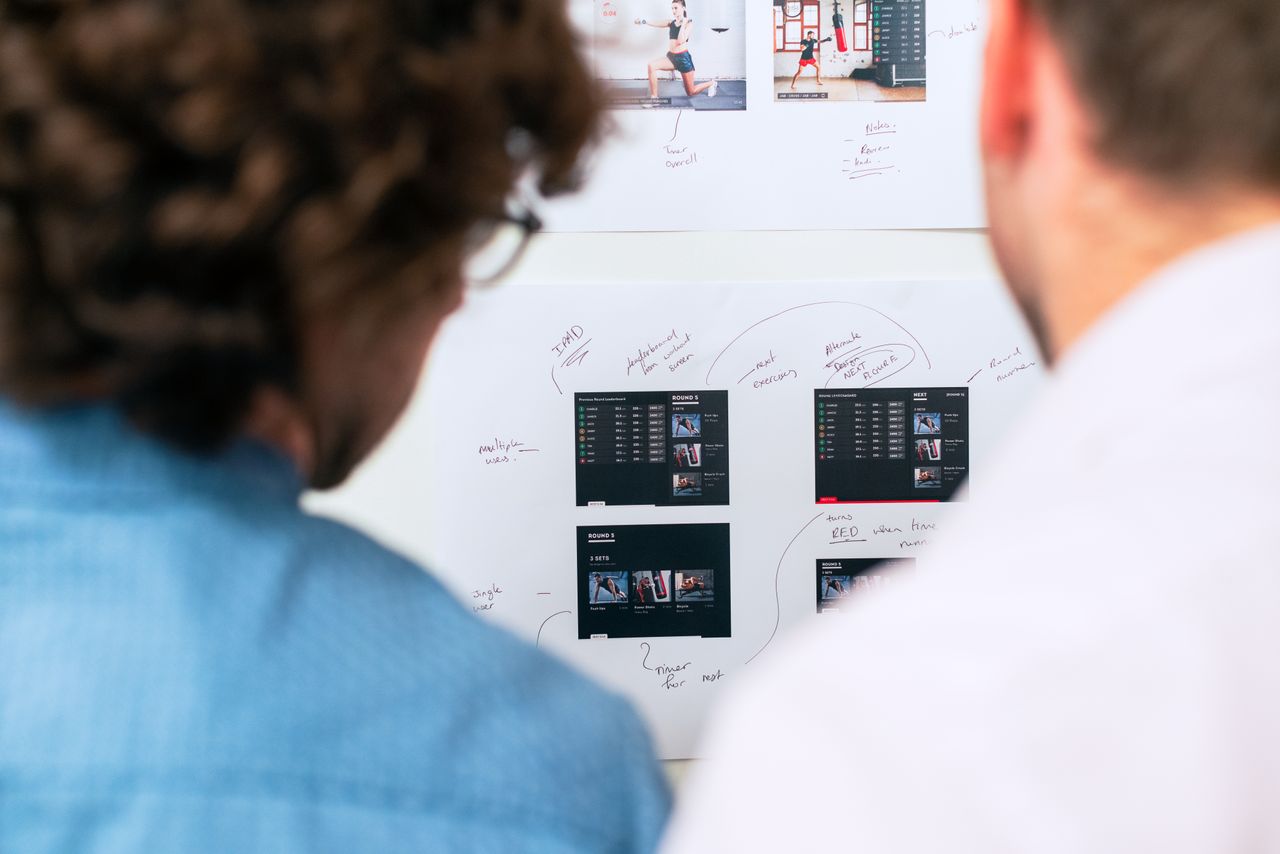 Two people figuring out how they would map out their website