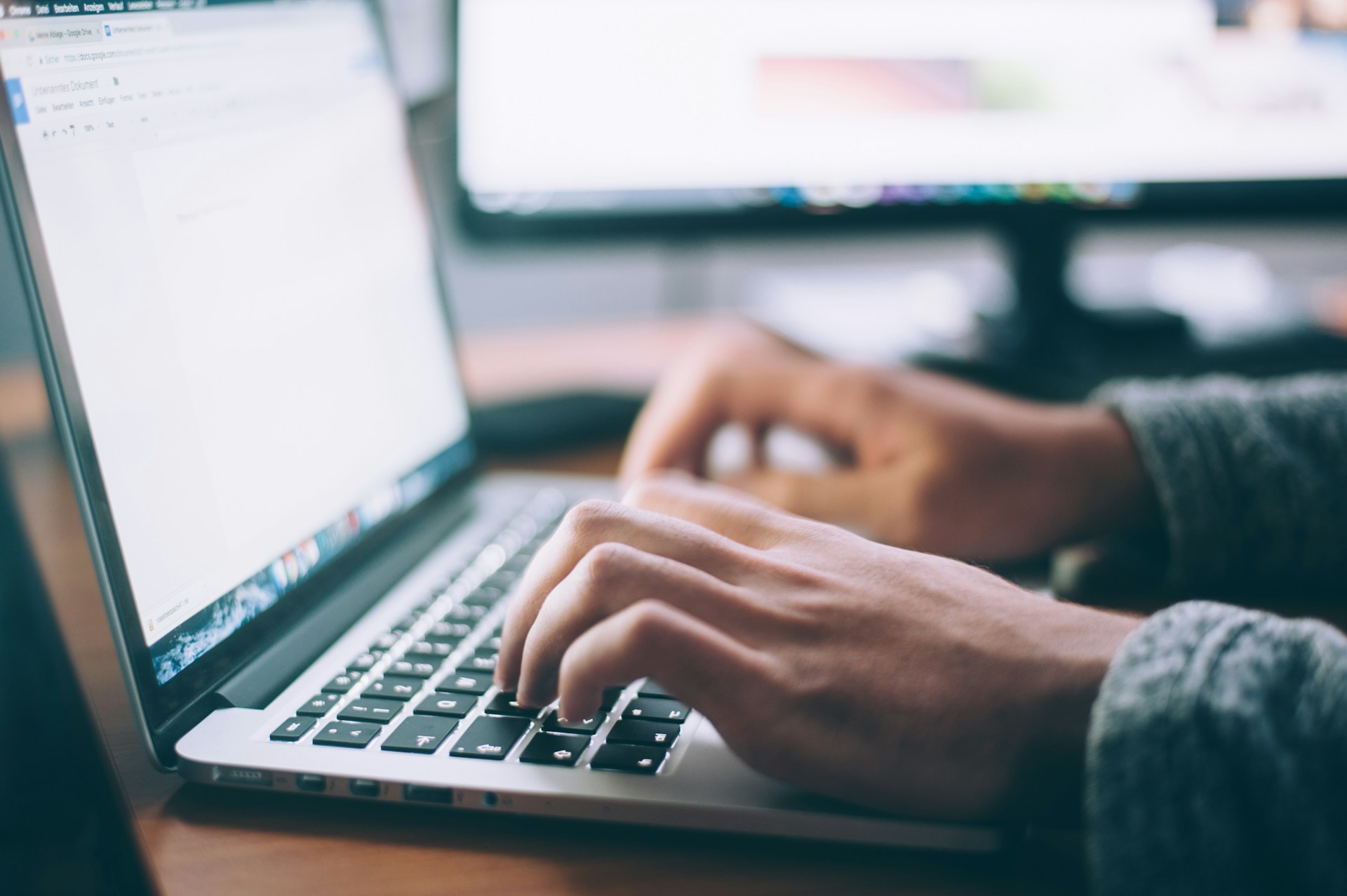 A person using a laptop to create content